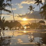 Sonnenuntergang am Infinity-Pool des Hilton La Romana – Blick aufs Meer mit Palmen und Strohdächern